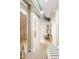 Hallway with exposed ductwork, neutral paint, decorative wall hangings, and carpet leading into sitting area and bedroom at 3198 Blake St # 402, Denver, CO 80205
