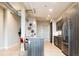 Modern kitchen with stainless steel appliances, central island, and decor at 3198 Blake St # 402, Denver, CO 80205