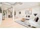 Spacious open-concept living area featuring exposed ductwork, hardwood floors, stylish furnishings, and a view into the kitchen at 3198 Blake St # 402, Denver, CO 80205
