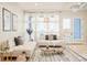 Bright living room features modern furnishings, large windows, and stylish decor at 3198 Blake St # 402, Denver, CO 80205