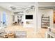 Open-concept living area featuring hardwood floors, exposed ductwork, modern furniture, and a large black and white art print at 3198 Blake St # 402, Denver, CO 80205