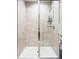 Modern shower with stylish light tile, glass enclosure, and contemporary fixtures at 3198 Blake St # 402, Denver, CO 80205