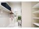 Well-organized walk-in closet with ample shelving, mirror, and integrated storage solutions at 3198 Blake St # 402, Denver, CO 80205