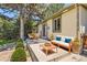 Charming backyard patio featuring outdoor seating and mature trees at 4111 S Delaware St, Englewood, CO 80110