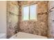 Bathroom with tile surround window over tub and shower combination at 4111 S Delaware St, Englewood, CO 80110