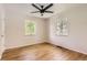 Bright bedroom with hardwood floors, neutral paint, and a modern ceiling fan at 4111 S Delaware St, Englewood, CO 80110