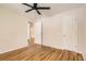 Bedroom featuring hardwood flooring, neutral paint, ceiling fan, and closet at 4111 S Delaware St, Englewood, CO 80110