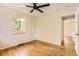 Light bedroom with hardwood floors, neutral paint, and views to the exterior at 4111 S Delaware St, Englewood, CO 80110