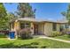 Charming single-story home featuring a well-manicured lawn and a welcoming red front door at 4111 S Delaware St, Englewood, CO 80110