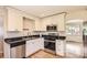 Updated kitchen with stainless steel appliances, white cabinetry, and modern fixtures at 4111 S Delaware St, Englewood, CO 80110