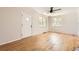 Spacious living room featuring hardwood floors, a ceiling fan, and ample natural light at 4111 S Delaware St, Englewood, CO 80110