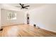 Bright living room featuring hardwood floors, neutral walls, and a modern ceiling fan at 4111 S Delaware St, Englewood, CO 80110