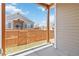 View of the back porch with wooden support beams and a wooden fence surrounding the backyard at 11482 Colony Loop, Parker, CO 80138