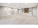 Spacious basement featuring built-in shelving, recessed lighting, and neutral carpet at 11482 Colony Loop, Parker, CO 80138