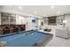 Basement game and living area with pool table, bar, chairs and sofa at 11482 Colony Loop, Parker, CO 80138