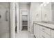 Bright bathroom showcasing double sinks, granite countertop, tile floors, and walk-in closet at 11482 Colony Loop, Parker, CO 80138