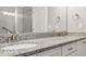 Bathroom featuring a double sink vanity with granite countertops and modern fixtures at 11482 Colony Loop, Parker, CO 80138