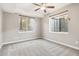 Bedroom with neutral carpet and paint with egress windows to window wells at 11482 Colony Loop, Parker, CO 80138