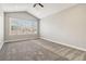 Spacious bedroom featuring carpet flooring and large window with blinds that allows ample natural light at 11482 Colony Loop, Parker, CO 80138