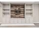 Close up of basement built-in shelving unit with rustic wood backdrop at 11482 Colony Loop, Parker, CO 80138