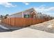 A view of the home exteriors lined up on a street with a wooden fence separating the yards at 11482 Colony Loop, Parker, CO 80138
