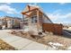 View of a home with a covered stone porch, a white railing and a landscaped yard at 11482 Colony Loop, Parker, CO 80138