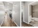 Hallway with wood floors, neutral walls, and views into the open floor plan at 11482 Colony Loop, Parker, CO 80138