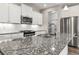 Modern kitchen featuring white cabinets, granite countertops, stainless steel appliances and a stylish faucet at 11482 Colony Loop, Parker, CO 80138