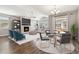 Open-concept living and dining area with modern furniture, a fireplace, and a sliding door with outside view at 11482 Colony Loop, Parker, CO 80138