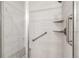Bright shower featuring white subway tile, glass door, and built-in shower niche at 11482 Colony Loop, Parker, CO 80138