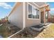 Side yard view of the home showing the home's siding, a window, and the basement egress window at 11482 Colony Loop, Parker, CO 80138