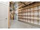 Unfinished basement with exposed ceiling, concrete floor, shelving, and utilities at 11482 Colony Loop, Parker, CO 80138