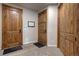 Unfinished basement area with three rustic wood paneled doors at 11405 Conifer Ridge Dr, Conifer, CO 80433