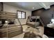 Bedroom featuring two sets of bunk beds, a cowhide rug, and a dark accent wall with nice natural light at 11405 Conifer Ridge Dr, Conifer, CO 80433
