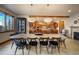 Stylish dining room with a large table, modern light fixtures, and an open view to the kitchen area at 11405 Conifer Ridge Dr, Conifer, CO 80433