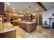 Kitchen with island, stone tile floor, modern appliances, and a view of an adjacent sitting area at 11405 Conifer Ridge Dr, Conifer, CO 80433