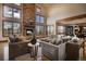 Beautiful living room with vaulted ceilings, a stone fireplace, comfortable seating, and natural light at 11405 Conifer Ridge Dr, Conifer, CO 80433