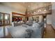 Expansive living area featuring vaulted ceilings, elegant decor, and an open layout connecting to other spaces at 11405 Conifer Ridge Dr, Conifer, CO 80433