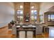 Elegant living room with a stone fireplace, hardwood floors, and large windows showcasing the outdoor scenery at 11405 Conifer Ridge Dr, Conifer, CO 80433