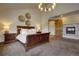 A nicely staged primary bedroom features a decorative fireplace and wooden door at 11405 Conifer Ridge Dr, Conifer, CO 80433