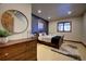 Modern bedroom with decorative mirror, dark accent wall, wood furniture, and large window at 11405 Conifer Ridge Dr, Conifer, CO 80433