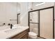 Bathroom features a single sink with vanity and a glass enclosed shower at 668 Leafy Aster Ln, Castle Rock, CO 80104