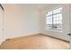 Bright room features hardwood floors, a large window, white trim, and neutral paint at 668 Leafy Aster Ln, Castle Rock, CO 80104