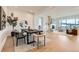 Modern dining room adjacent to the living room with hardwood flooring and sophisticated decor at 668 Leafy Aster Ln, Castle Rock, CO 80104