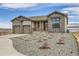 Beautiful single-Gathering home featuring a neutral color palette, stone accents, and low maintenance rock landscaping at 668 Leafy Aster Ln, Castle Rock, CO 80104