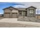 Charming single-Gathering home showcasing a neutral color palette, stone accents, and a well-manicured lawn at 668 Leafy Aster Ln, Castle Rock, CO 80104