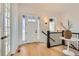 Bright foyer with hardwood floors, a stylish light fixture, and a decorative table creating a welcoming entry at 668 Leafy Aster Ln, Castle Rock, CO 80104