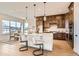Stunning kitchen with wood cabinets, white island, granite countertops, and stainless steel appliances at 668 Leafy Aster Ln, Castle Rock, CO 80104