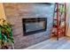 Modern electric fireplace with decorative stones and shelving in the living room at 1739 E Martin Luther King Jr Blvd, Denver, CO 80205