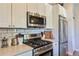 Clean kitchen with stainless appliances, gas range, and white subway tile backsplash at 1739 E Martin Luther King Jr Blvd, Denver, CO 80205